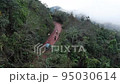 Traveling by van through the foggy jungle in Puebla state in Mexico 95030614