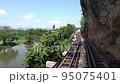The Cliff of death railway bridge in Kanchanaburi, Thailand. 95075401