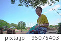 Girl sitting in Ayutthaya ruin while traveling in Thailand. 95075403