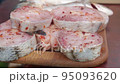 Raw fish steaks marinated handheld shot 95093620