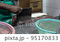 Penang, Malaysia 07172021- Wet market cutting off head of fish 95170833