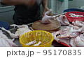 Penang, Malaysia 07172021- Wet market cutting chicken legs 95170835