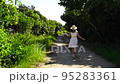 A woman running on a beautiful road in Okinawa 95283361