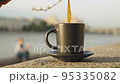 Cup of coffee on a granite parapet 95335082
