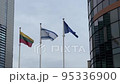 Flags of Lithuania, Israel and European Union flying between business center buildings in Vilnius 95336900