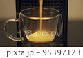 Espresso being poured into transparent cup in coffee machine 95397123