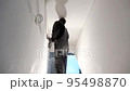 Professional worker with sandpaper prepare wall for painting. Handheld motion shot. 95498870
