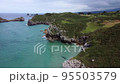 Aerial View of rocky coastline with cliffs and the old ruins of a hermitage 95503579