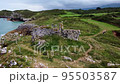 Aerial View of rocky coastline with cliffs and the old ruins of a hermitage 95503587