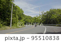 A motorcycle running on the curve of the road 95510838