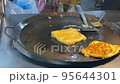 The scene of cooking fried egg banana  cake in Ho Thi Ky Street food, Ho Chi Minh City, Vietnam 95644301