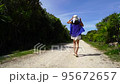 A woman running on a beautiful road in Okinawa 95672657