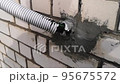 Destroyed, broken protection of electrical cable entry into the house. 95675572
