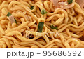 Picking up instant abura soba with chopsticks 95686592