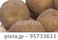 Potatoes on a colander up rotation white background 95733611