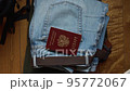 Russian documents and cash money are lying on a stick of things, the man is going to leave Russia. 95772067
