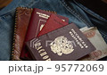 Russian documents and cash money are lying on a stick of things, the man is going to leave Russia. 95772069