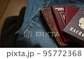 Russian documents and cash money are lying on a stick of things, the man is going to leave Russia. 95772368