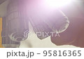 A Scientist rotates the microscope lenses. 95816365