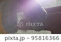 A Scientist rotates the microscope lenses. 95816366