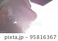 A Scientist rotates the microscope lenses. 95816367