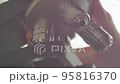 A Scientist rotates the microscope lenses. 95816370
