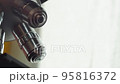A Scientist rotates the microscope lenses. 95816372