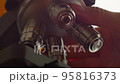 A Scientist rotates the microscope lenses. 95816373