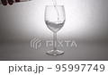 Zoom white back pouring carbonated water into a glass 95997749