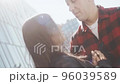 Man hugs a woman tightly and lovingly on the street on a sunny day. 96039589