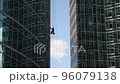 Industrial mountaineering. Window cleaner performs work between two skyscrapers 96079138