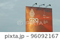 Flying plane in the sky and a billboard with a summit G20 logo in bali 96092167