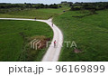 Cyclists riding along a dirt road. Drone aerial view 96169899