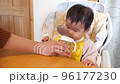 Baby drinking water from a straw mug 96177230