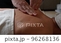 20 Therapeutic massage of the back and neck zone close-up half-face slow-motion 96268136