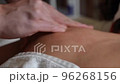 23 Therapeutic massage of the back of the scapula close-up fingers 96268156