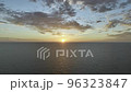 Sunset on the Ocean with a Clear Horizon Line and Cloudy Sky with Colorful Gradient 96323847