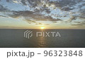 Sun Setting Down in the Ocean with a Beautiful Orange Sky with a Clear Horizon a Top Drone shot Dollying in 96323848