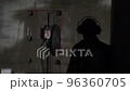 The process of cutting a concrete wall. The operator in special headphones watches the work of the concrete cutter. The round disc cuts concrete. Construction and redevelopment 96360705