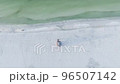 White Sandy Beach with Red Lifeguard Tower a Top Aerial Drone Shot at the Siesta Key in Florida 96507142