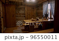 Dining room in old country home prepared for arrival of guests. Traditional Russian tea ceremony in sauna house. Modern electric samovar with set of cups and light snacks 96550011