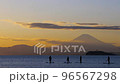 People who enjoy SUP while watching the orange sky and Mt. Fuji on the Zushi coast on a holiday 96567298