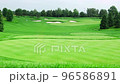 An empty green course with golf holes on clear summer day 96586891