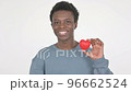 Young African Man Showing Red Heart on White Background  96662524