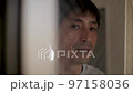部屋の中から憂鬱な表情でカメラの男性 50代日本人 スロー 部屋の中から憂鬱な表情でカメラの男性 50代日本人 スロー 97158036