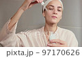 Skin care. Woman applying serum or facial oil on beauty face 97170626