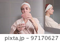 Skin care. Woman applying serum or facial oil on beauty face 97170627