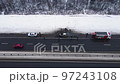 Misfortune - a burned-out car on the edge of a motorway, aerial view. 97243108