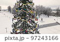 Golden and sparkling garlands on the Christmas tree, city square, aerial view. 97243166