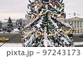 Aerial view, close-up of toys and flashing garlands on a Christmas tree. 97243173